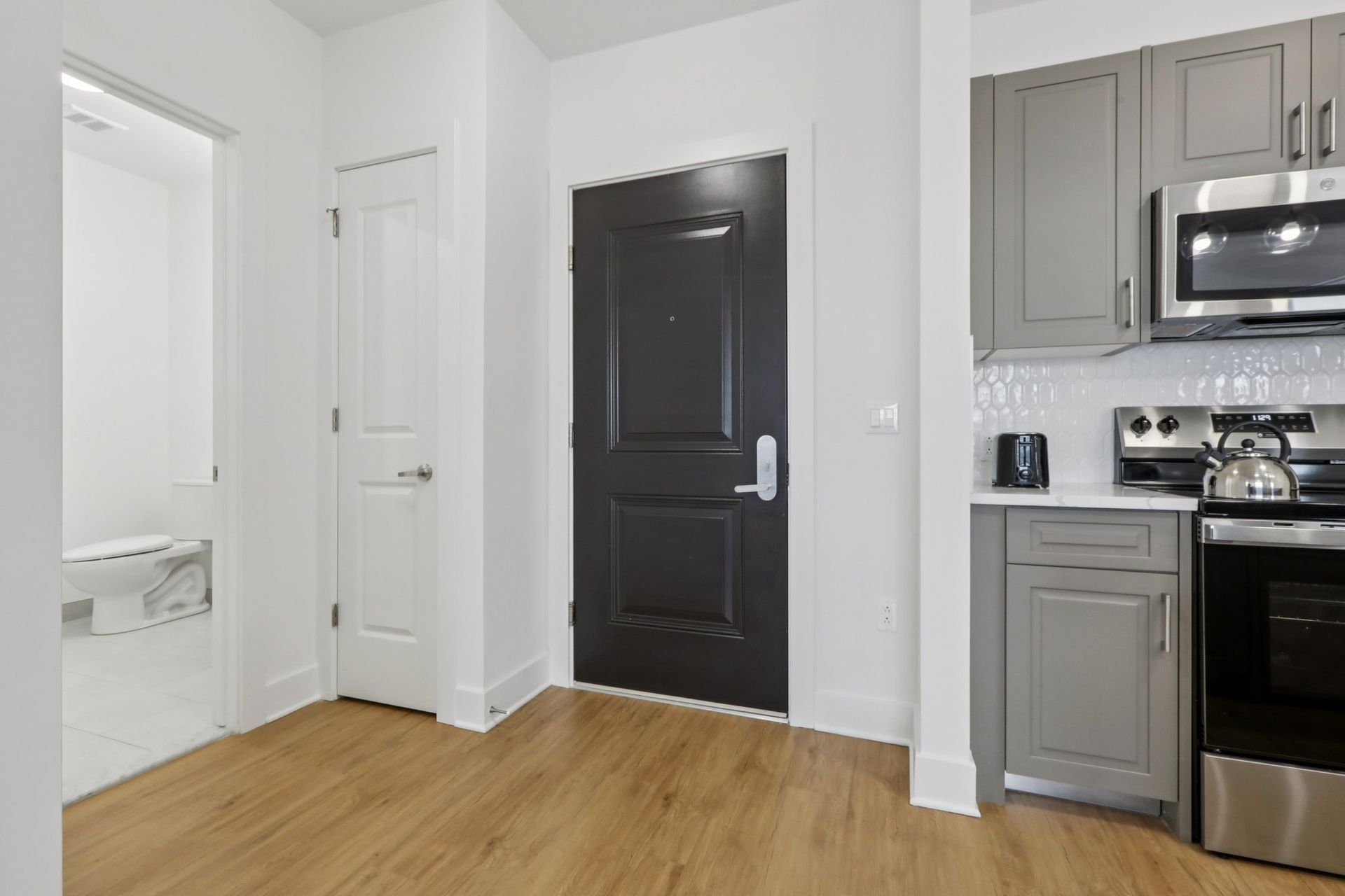Modern apartment door and kitchen at Meridia Little Ferry luxury apartments, Little Ferry NJ
