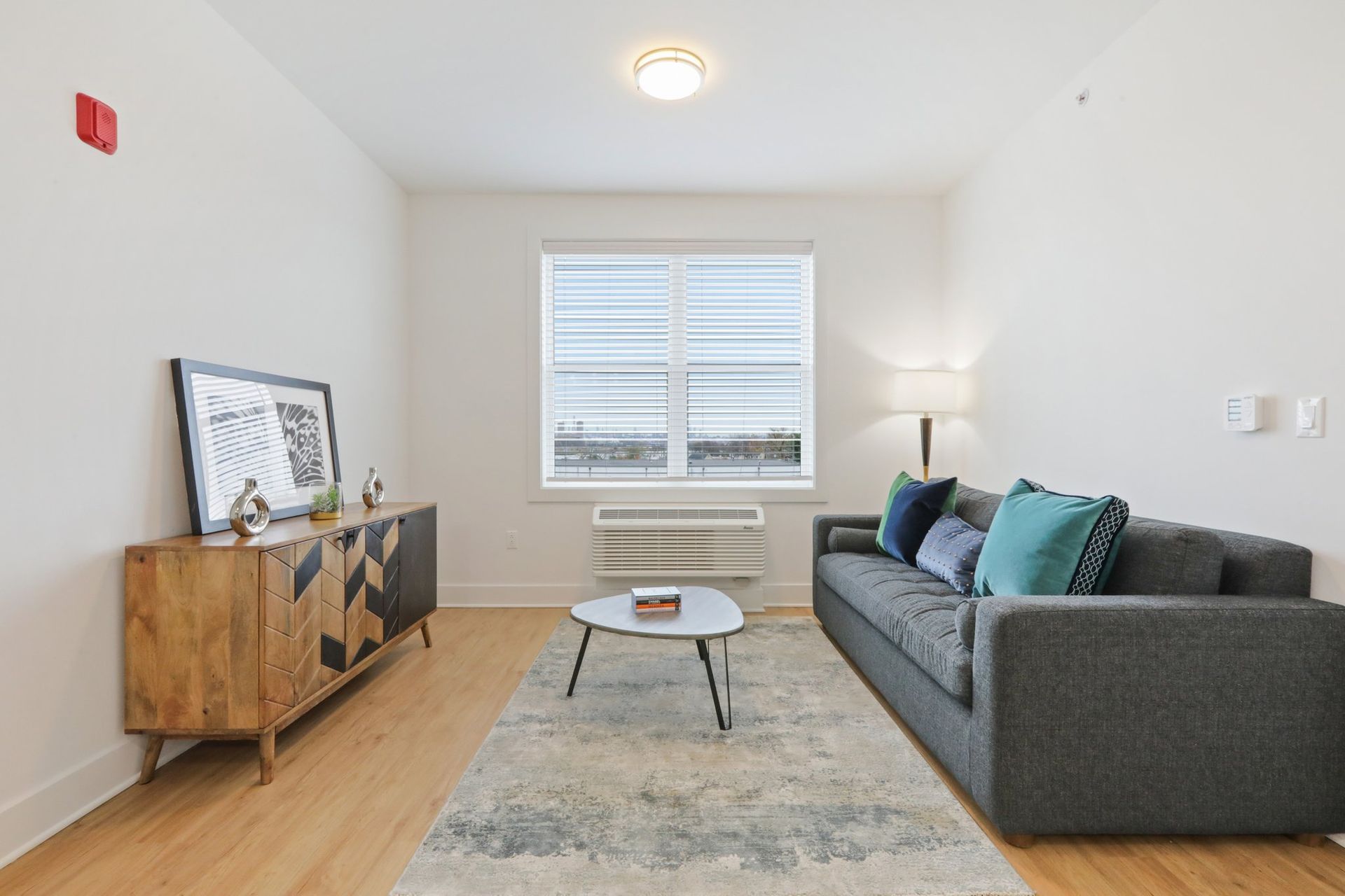 Comfortable living room with sofa and natural light at Meridia Little Ferry apartments NJ