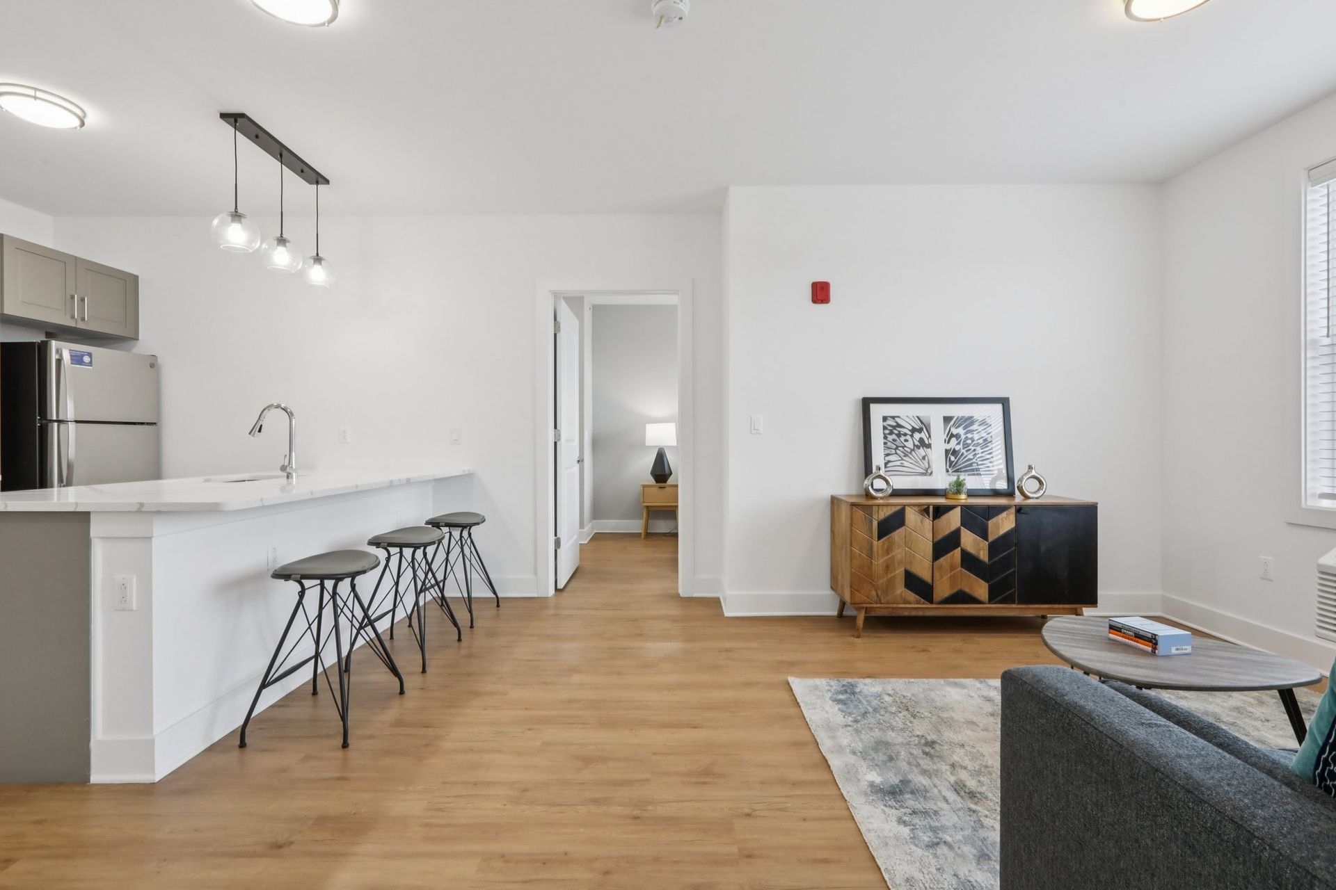 Kitchen and dining area with bar seating at Meridia Little Ferry luxury apartments NJ
