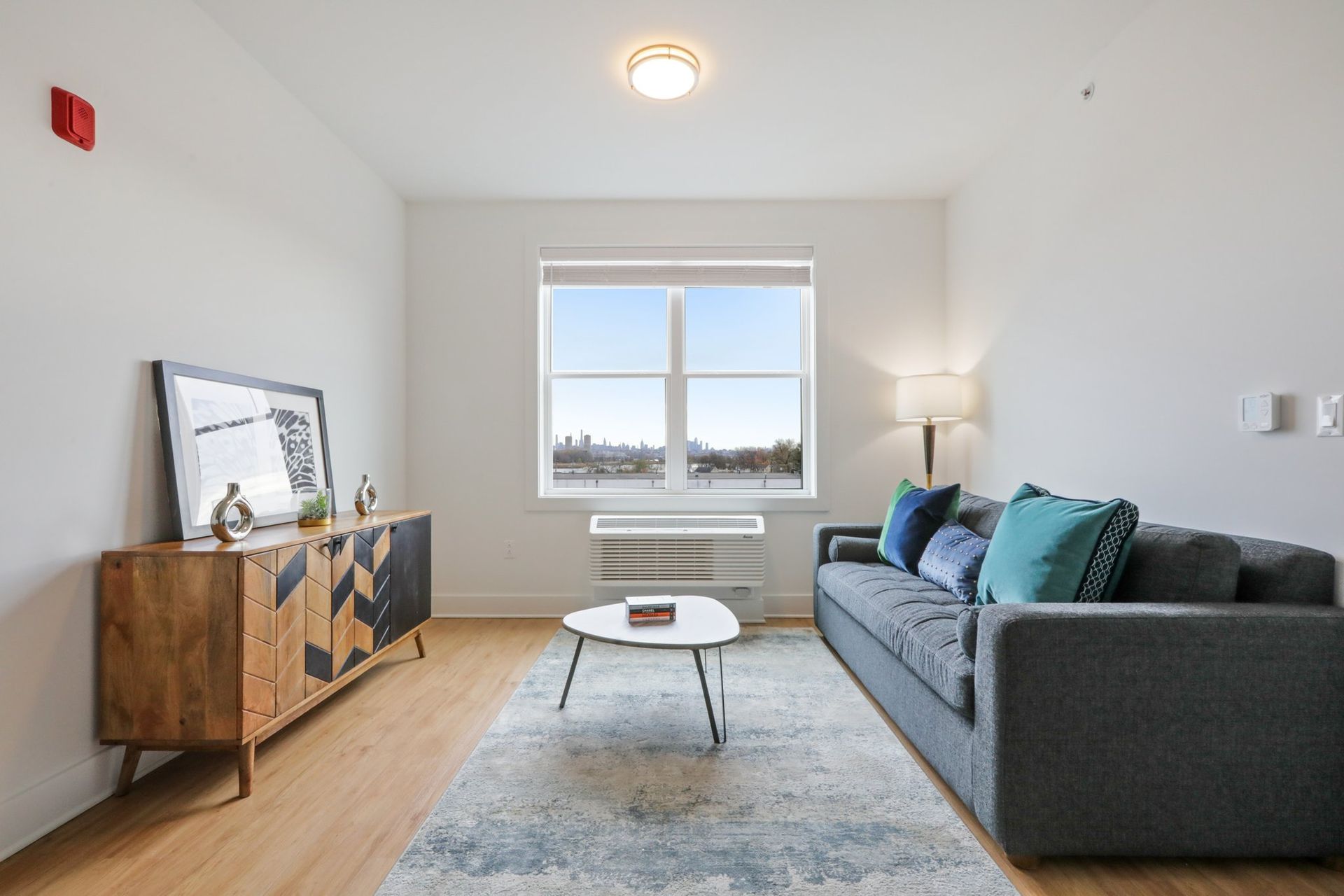Bright living room with large window and modern decor at Meridia Little Ferry NJ