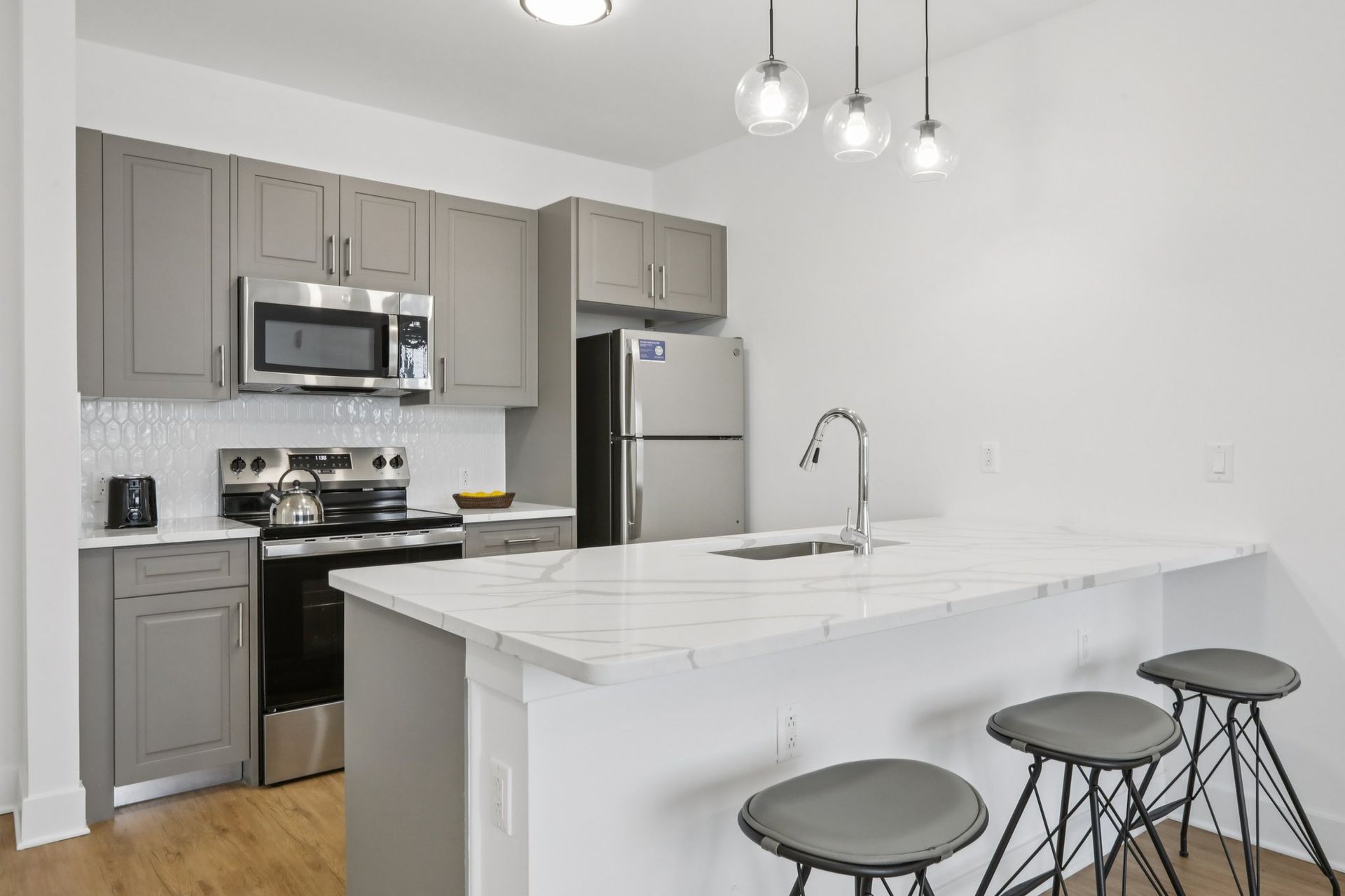 Gourmet kitchen with marble island and stainless appliances at Meridia Little Ferry NJ