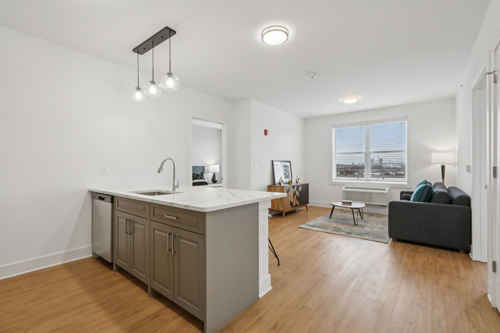 Open kitchen and living area with hardwood floors at Meridia Little Ferry, Little Ferry NJ