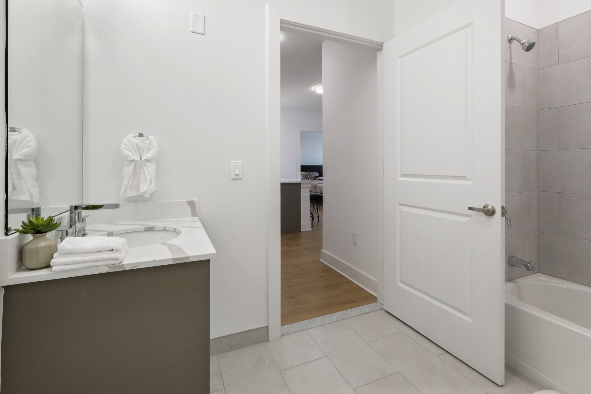 Elegant bathroom with walk-in shower and white vanity at Meridia Little Ferry apartments NJ