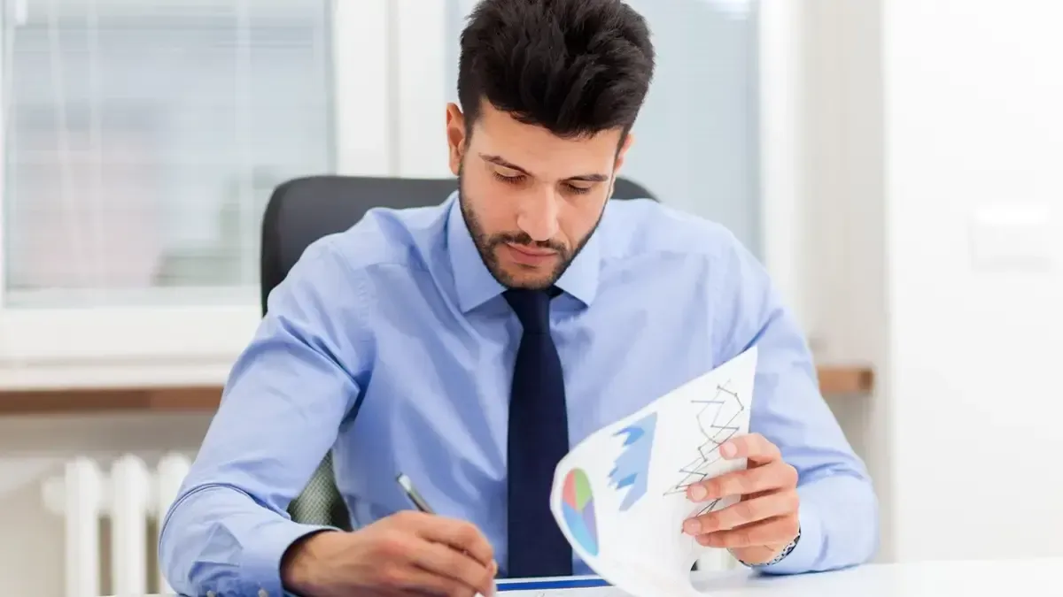 A businessman looking at a tax plan document
