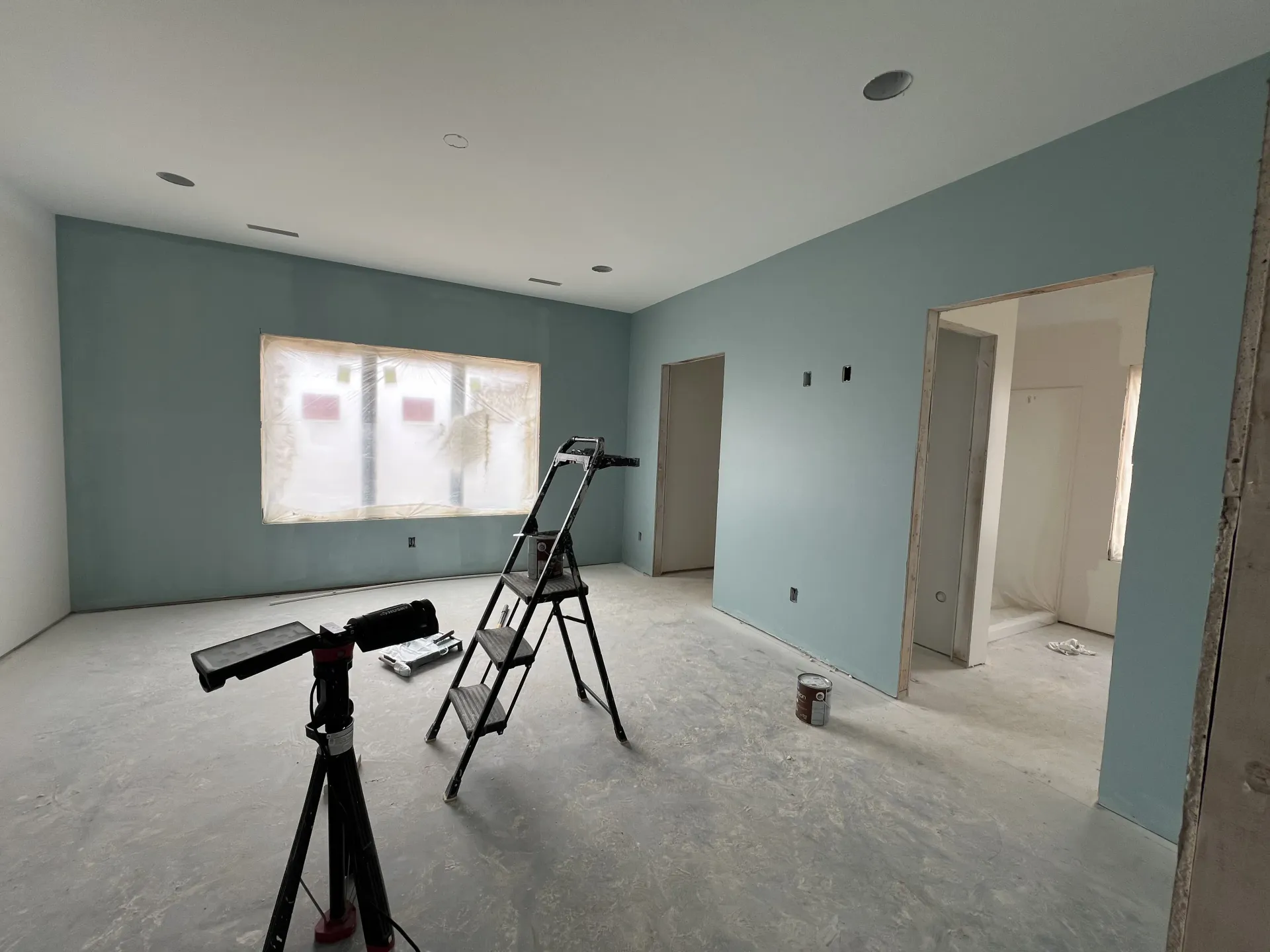 Residential interior painting in Rockford IL bedroom with blue accent walls and clean finish