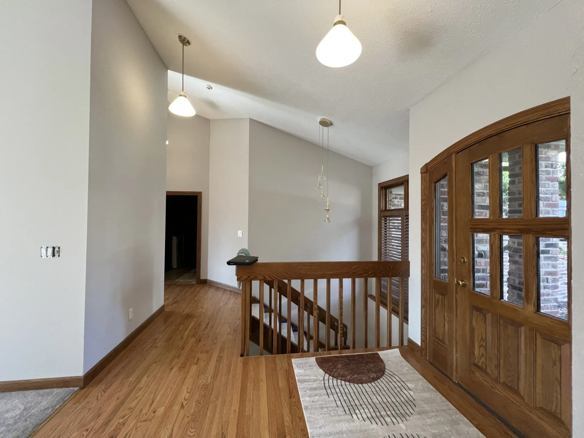 Residential interior painting project with freshly painted entryway walls and wood trim near Beloit WI
