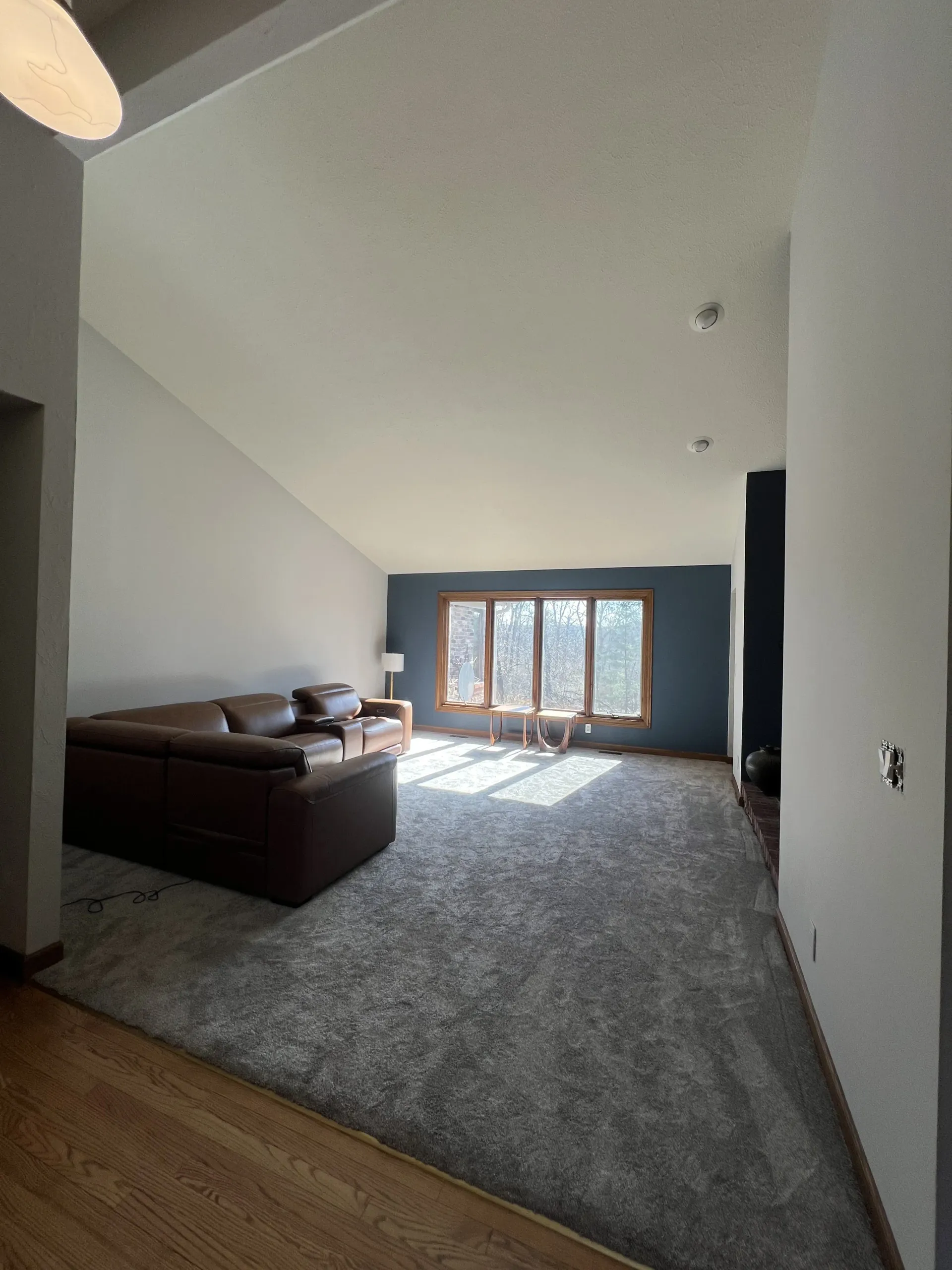 Interior painting project in Rockford IL with vaulted ceilings, white walls, and protected work area
