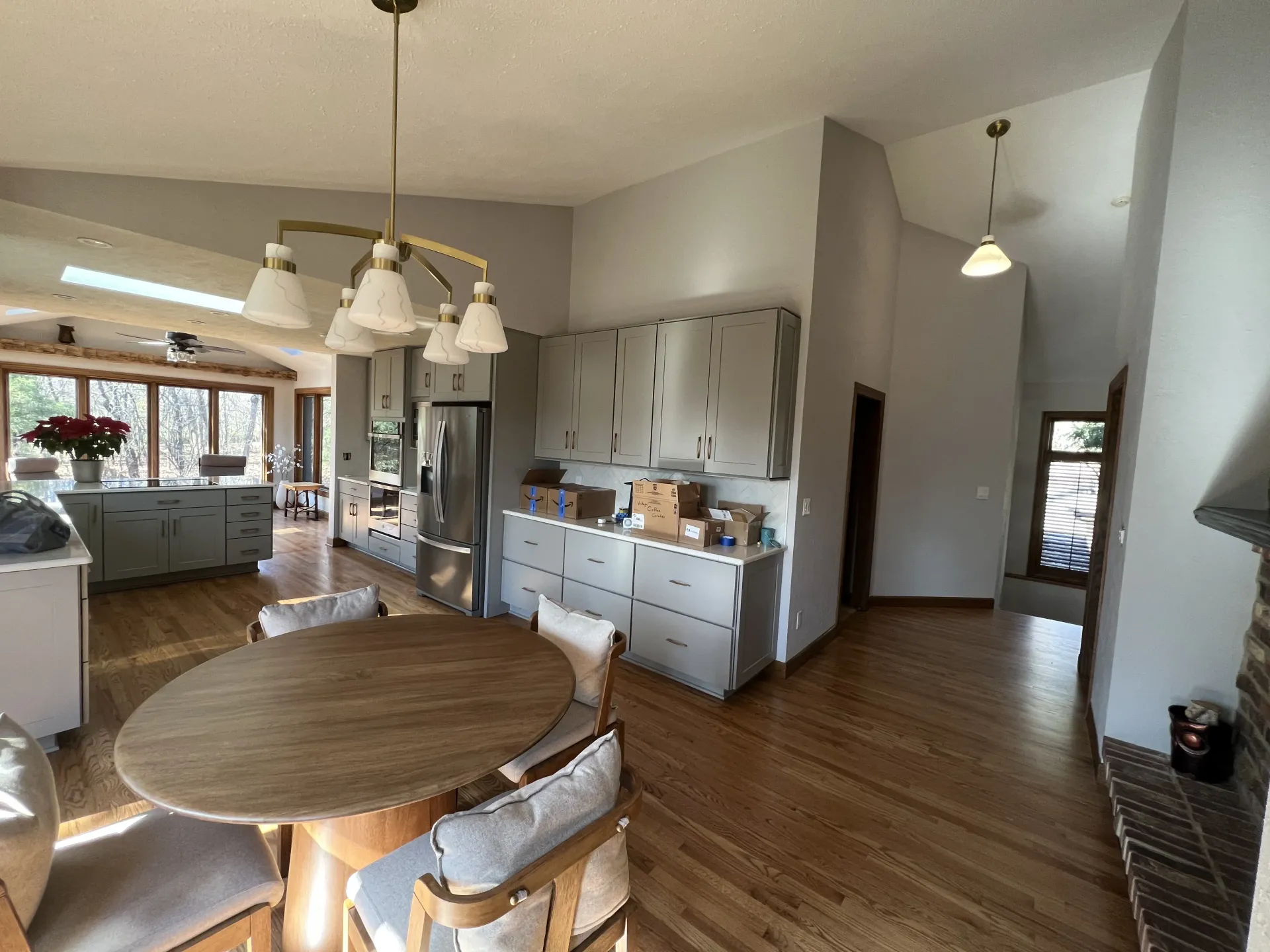 Finished kitchen and dining area with freshly painted neutral walls, updated cabinetry, and hardwood floors near Orfordville WI