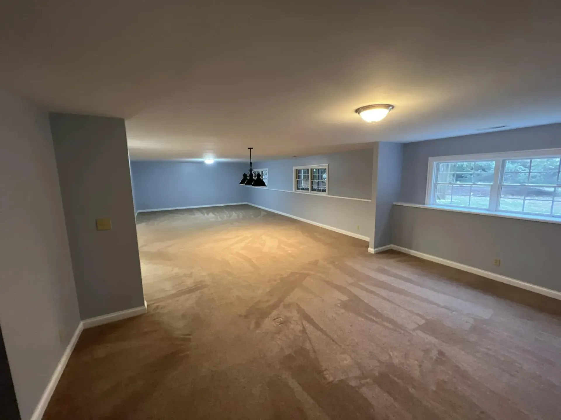 Finished basement interior painting project with smooth gray walls and white trim near Orfordville WI