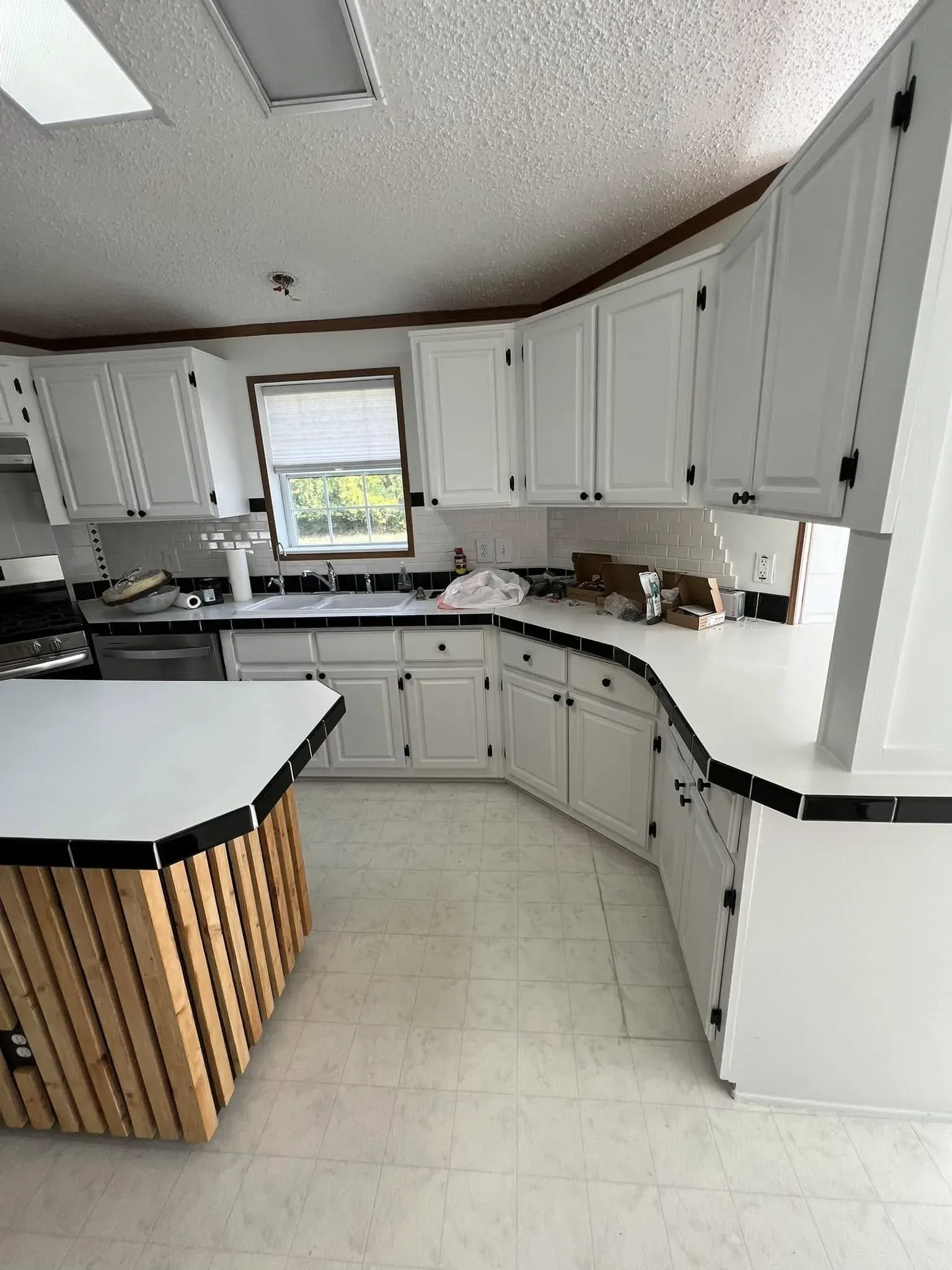 Finished kitchen interior painting project with brown accent walls and white trim near Belvidere IL