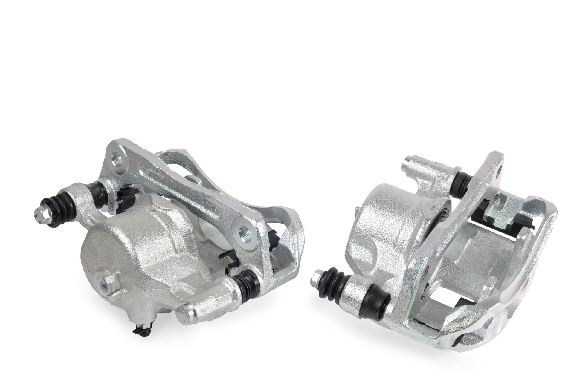 Two silver disc brake calipers with mounting brackets on a white background | Ron's Auto & RV