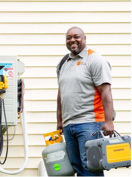 HVAC service technician outside a family home
