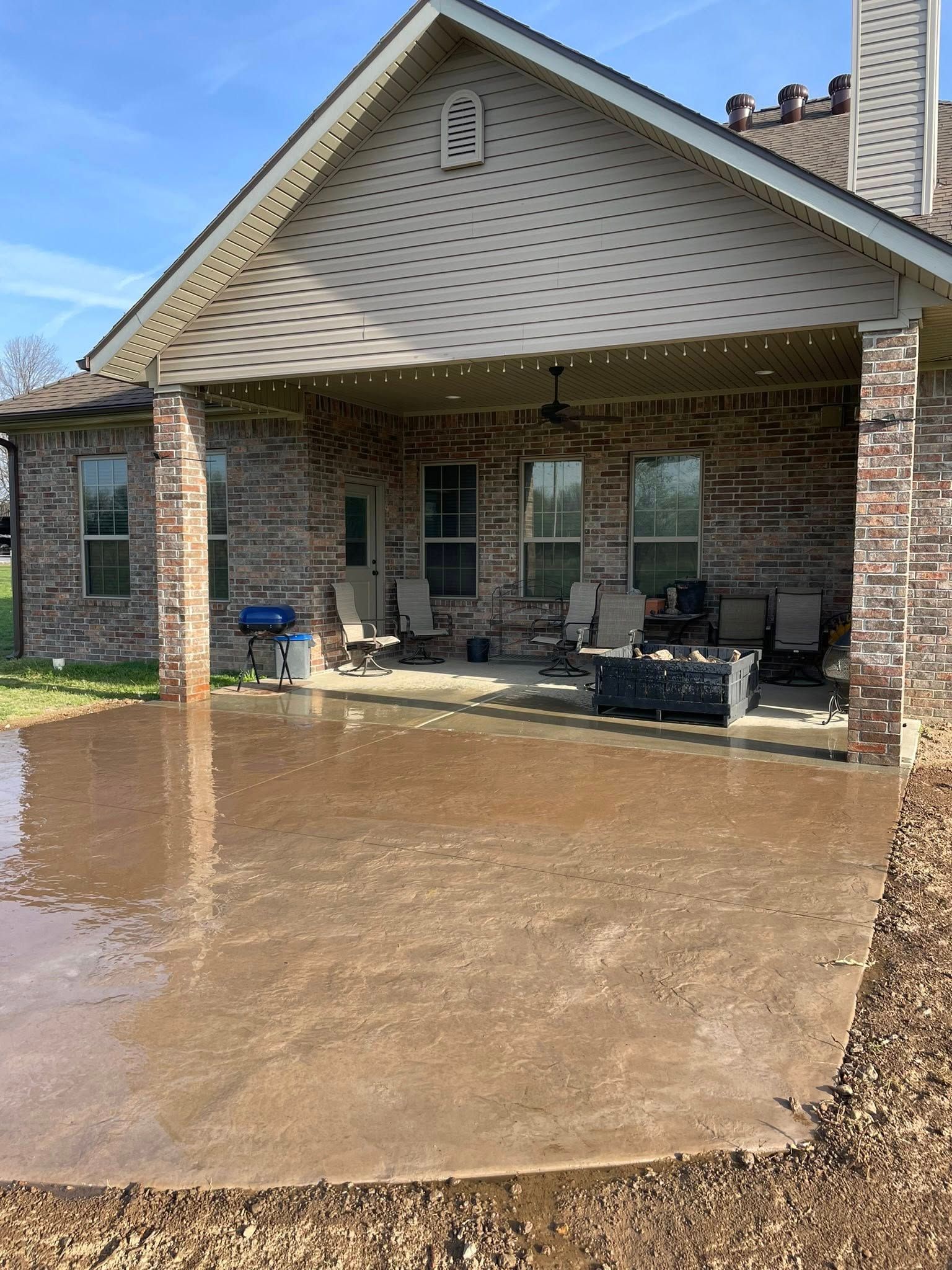 Flooded backyard patio beneath a covered roof after heavy rain
