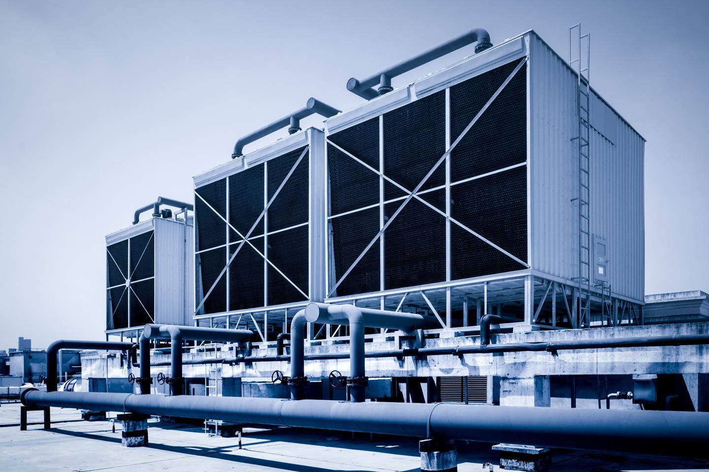 Cooling towers on a rooftop. Blue and white, with connected pipes and vents. San Jose's Best Commercial HVAC Business.