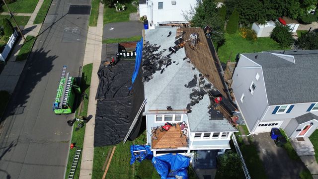 An aerial view of a roof being installed on a house.