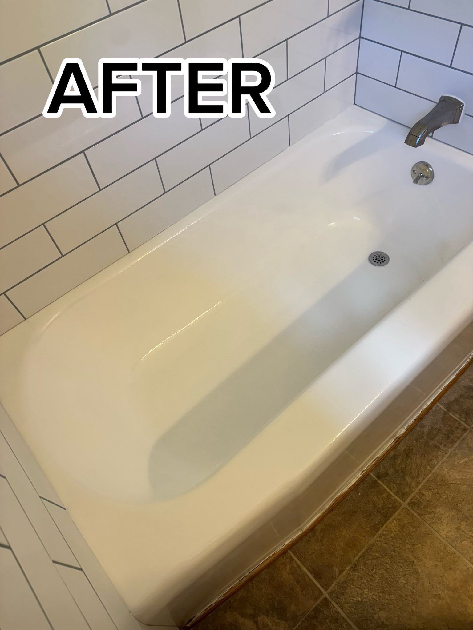 Bathtub with white tile surround and chrome faucet, labeled “AFTER” in the top left.