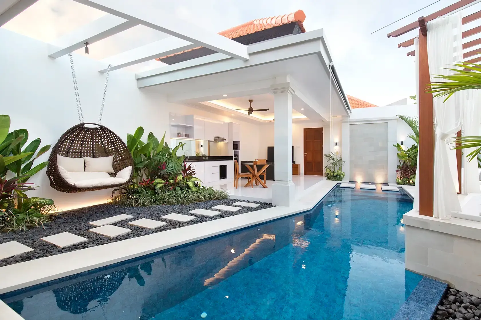 View on the private swimming pool, living room and hanging cocoon at Villa Mia Sanga in Seminyak, Bali
