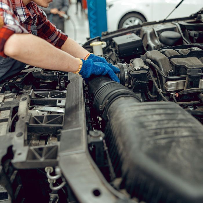 Gloved hands working on vehicle