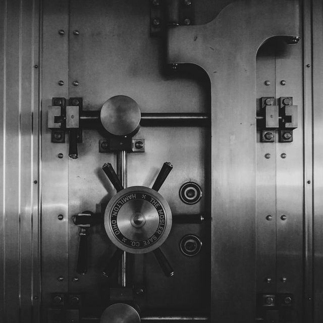 A black and white photo of a vault door.