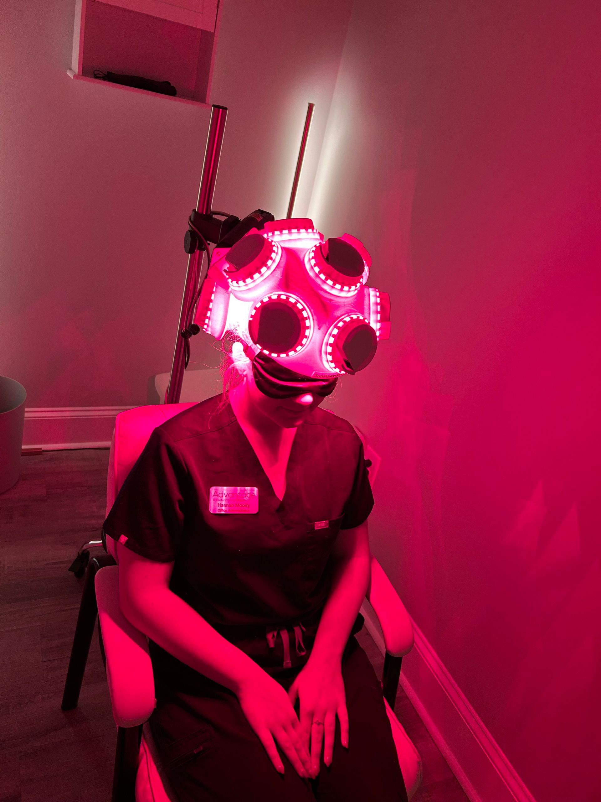 Patient receiving red light therapy helmet treatment for concussion at Advantage Therapy Solutions in Greenville, NC