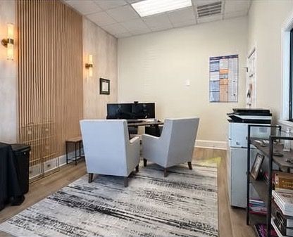 Private office with a desk and guest chairs
