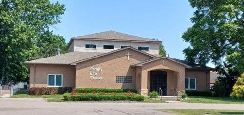 A beige building with a sign that says 