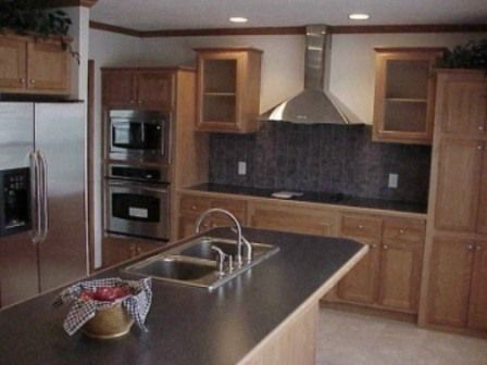 A kitchen with stainless steel appliances and wooden cabinets