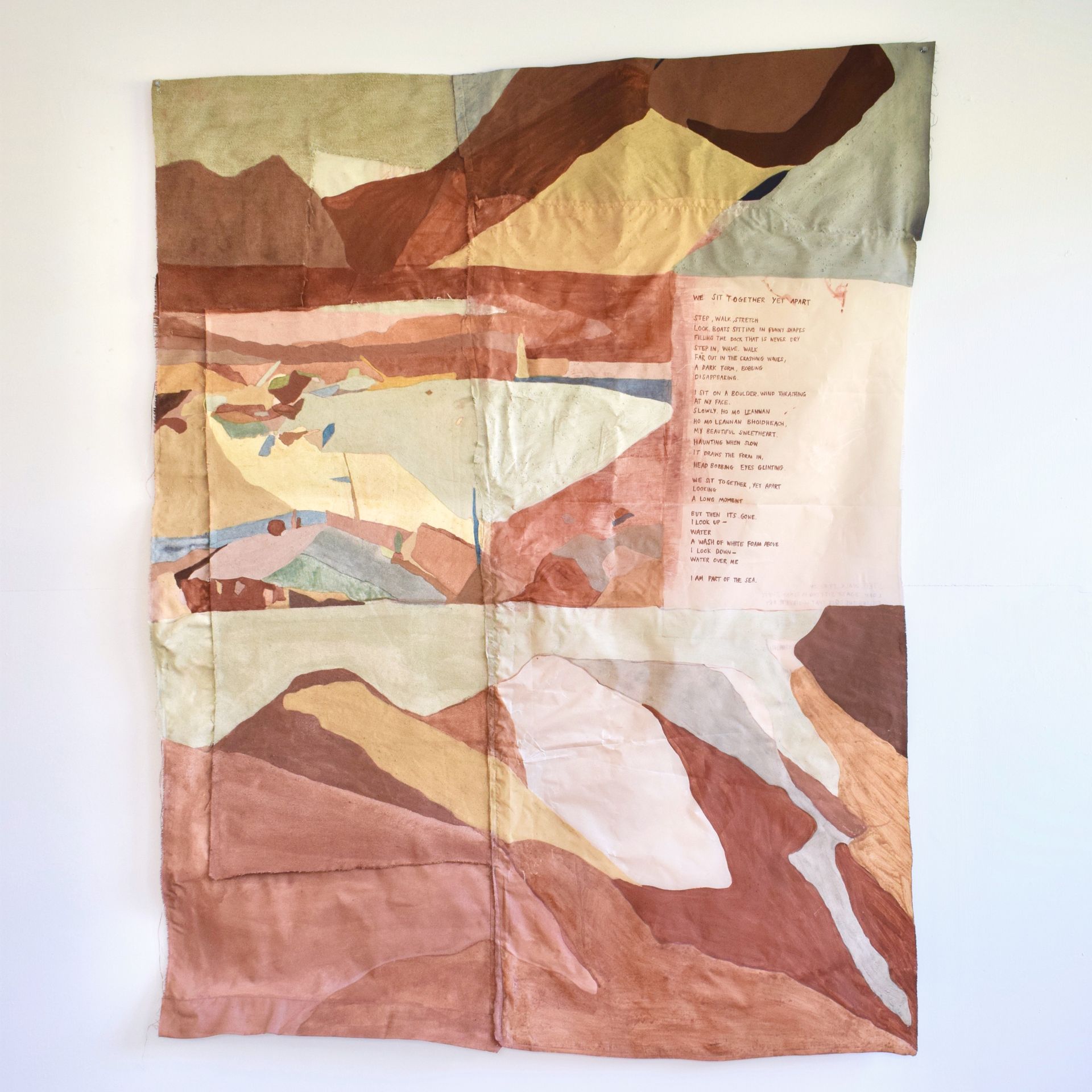 Photo of colourful painting on fabric depicting abstract landscape shapes