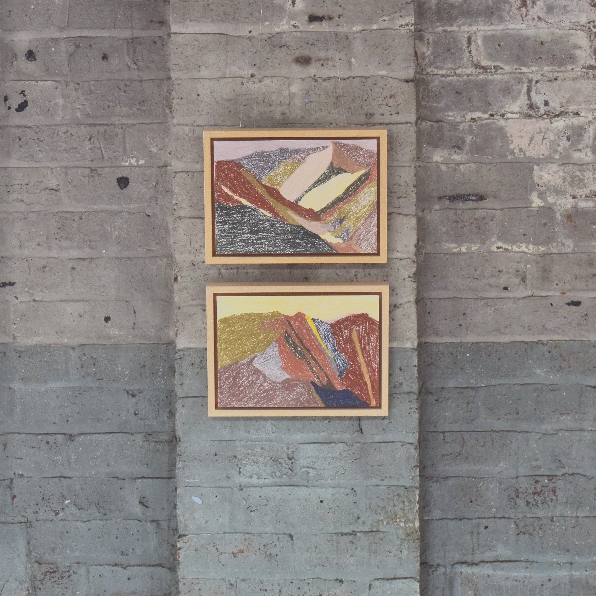 Small drawings on blue brick wall with large window