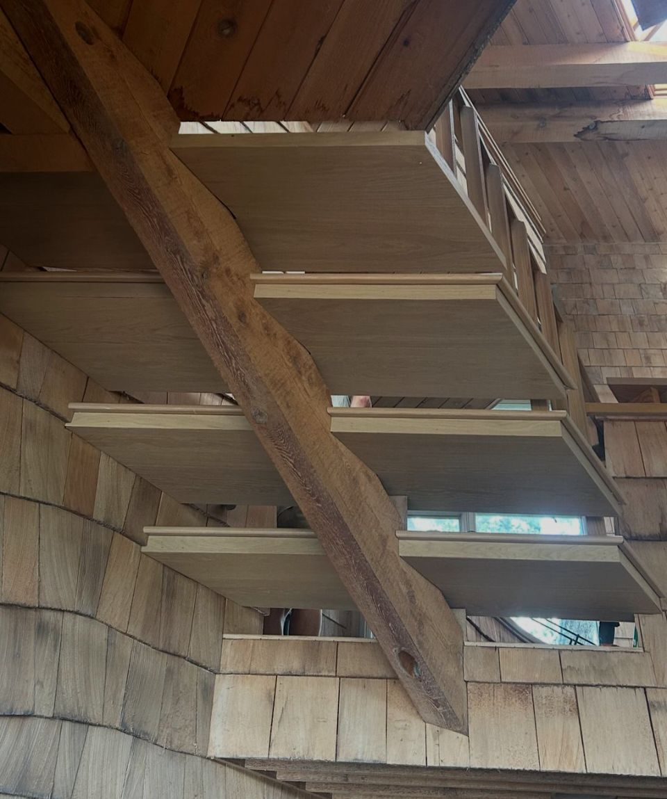 Floating wooden staircase installation showcasing precision craftsmanship and premium hardwood materials