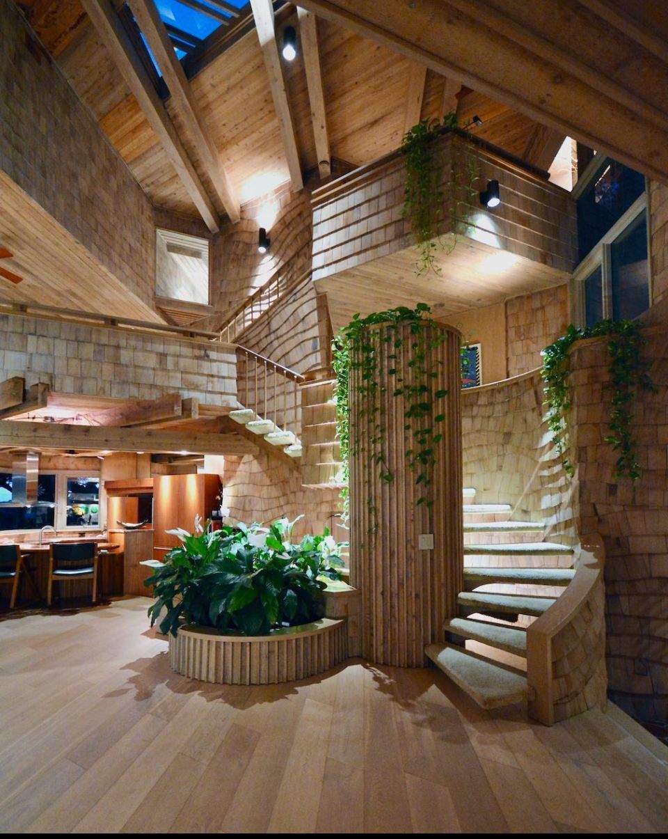 Luxury wood interior featuring curved staircase, laminate flooring, and natural design elements by Core Flooring FL