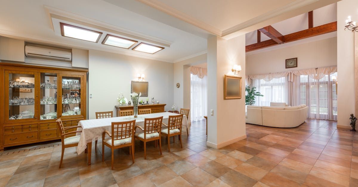 A large dining room with a long table and chairs.