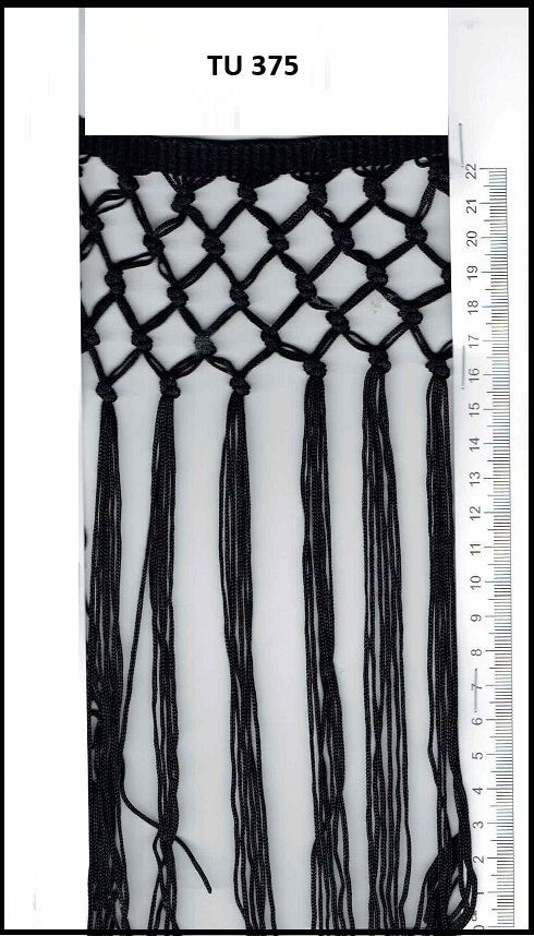 A black and white photo of a fringe with a ruler next to it