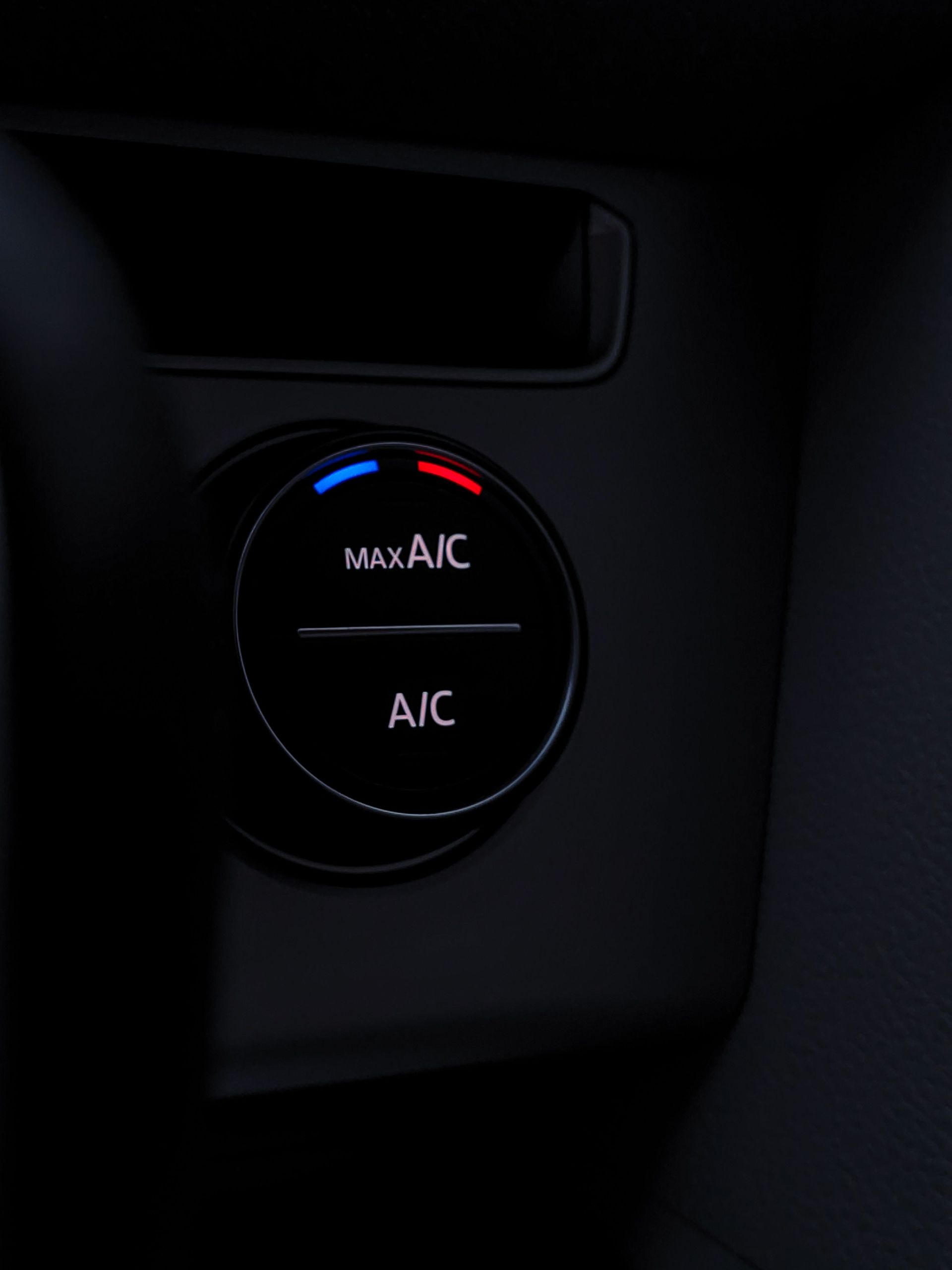 Car dashboard climate control knob with blue and red temperature markings and A/C, MAX A/C labels