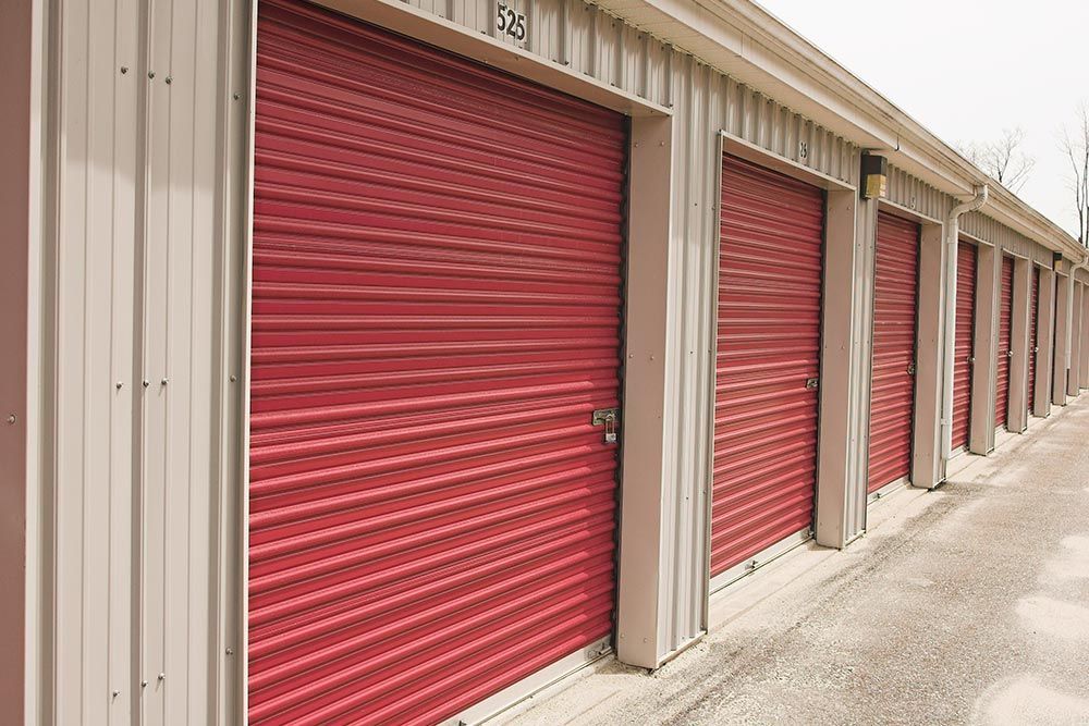 A row of red roll-off doors at Guardian Self Storage, showcasing efficient storage solutions in Cuya