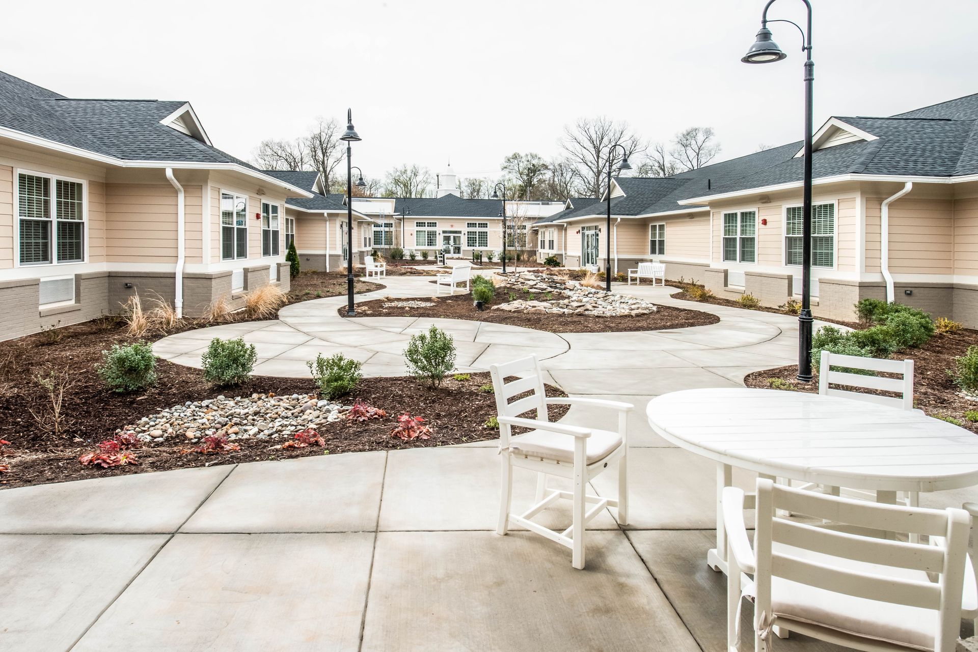 There is a table and chairs in the middle of the courtyard.