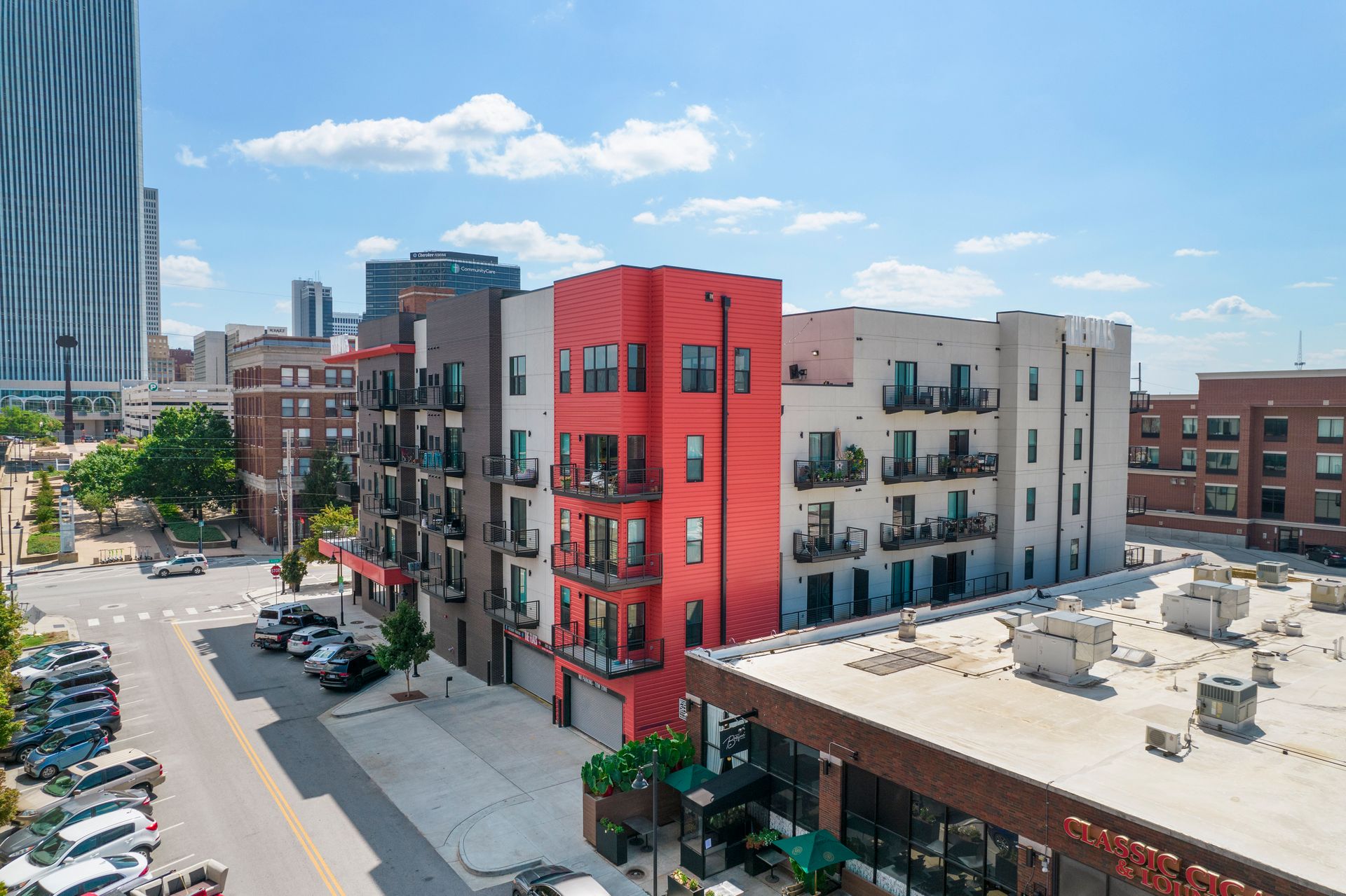 An aerial view of a red apartment building in a city.