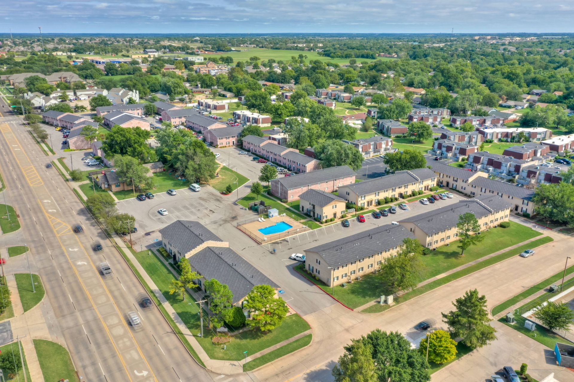 An aerial view of a residential area with a swimming pool.
