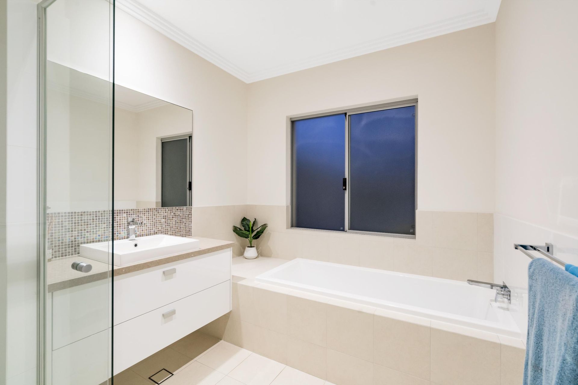 A Bathroom With A Tub, Sink, Mirror And Window — New England Glass & Aluminium In Armidale, NSW