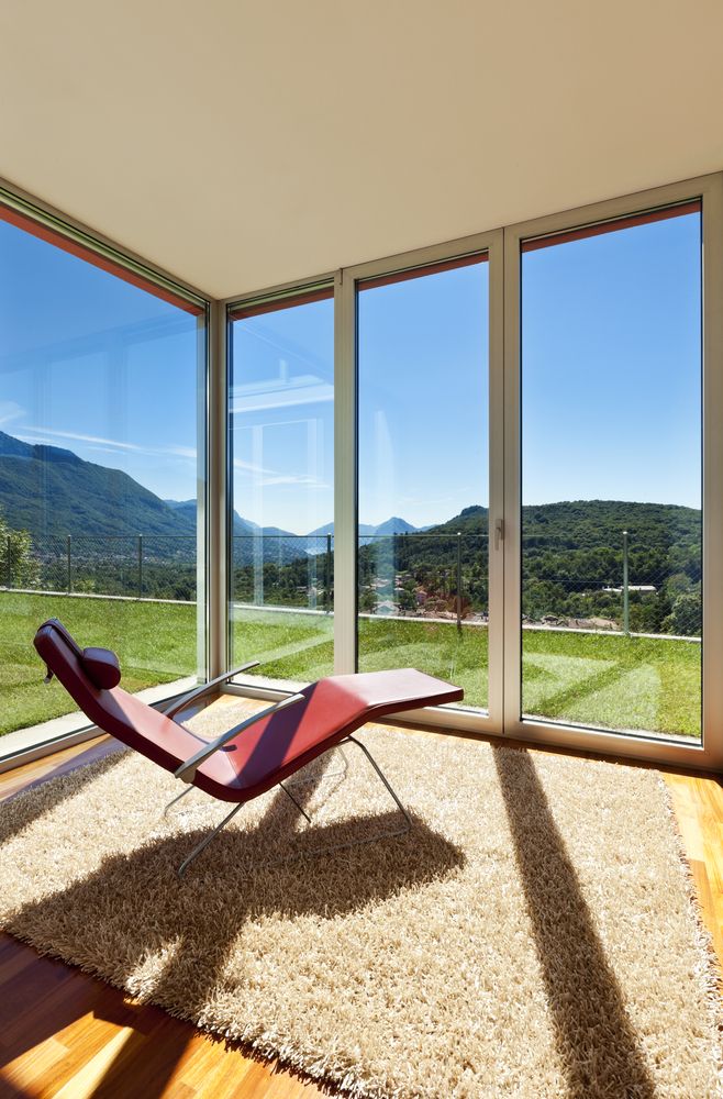 A Chair Is Sitting In A Room With A Lot Of Windows — New England Glass & Aluminium In Armidale, NSW