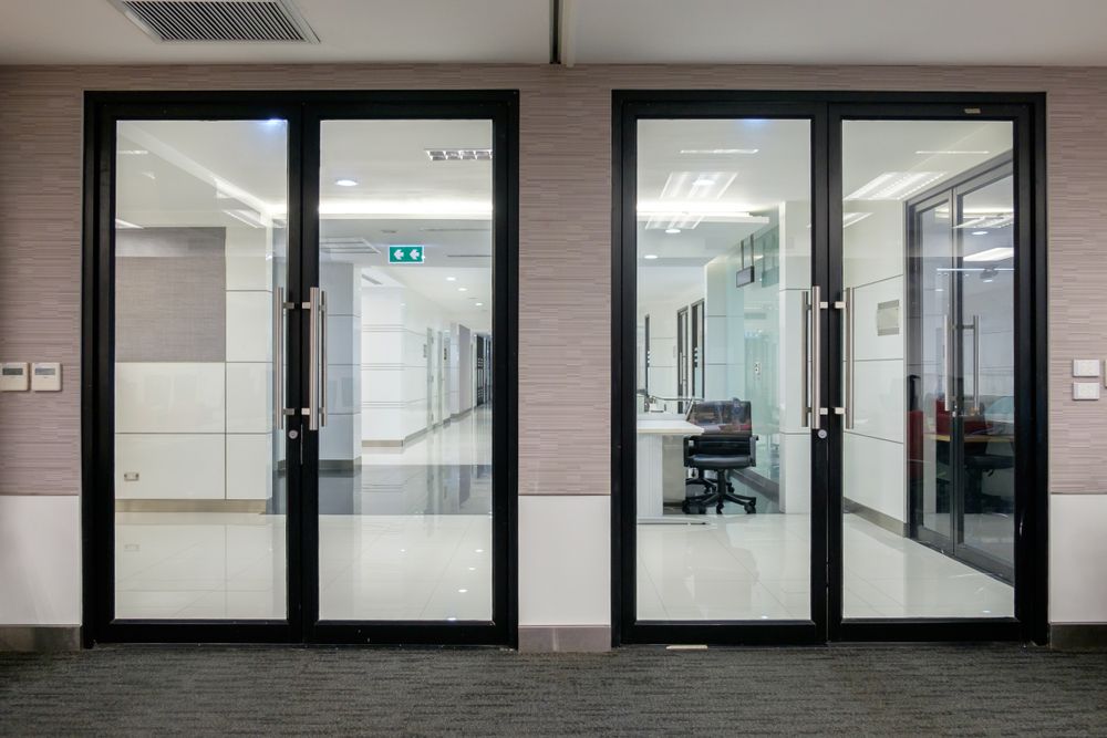 A Hallway With A Lot Of Glass Doors Leading To A Conference Room — New England Glass & Aluminium In Narrabri, NSW