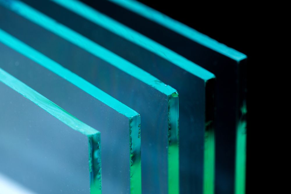 A Close Up Of Four Pieces Of Glass Stacked On Top Of Each Other On A Table — New England Glass & Aluminium In Tamworth, NSW