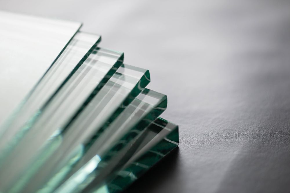 A Stack Of Glass Pieces Sitting On Top Of Each Other On A Table — New England Glass & Aluminium In Inverell, NSW