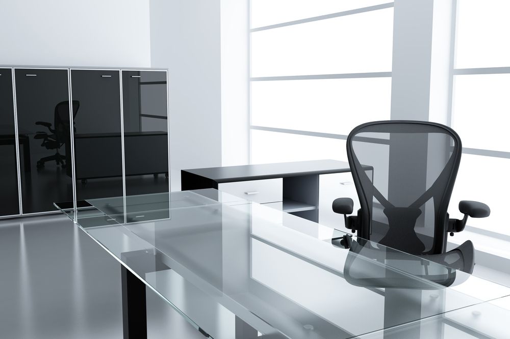 A Chair Sits At A Glass Desk In An Office — New England Glass & Aluminium In Armidale, NSW