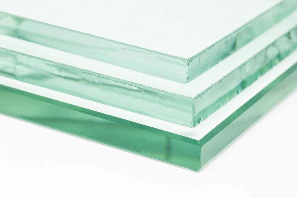 Three Pieces Of Glass Are Stacked On Top Of Each Other On A White Surface — New England Glass & Aluminium In Moree, NSW