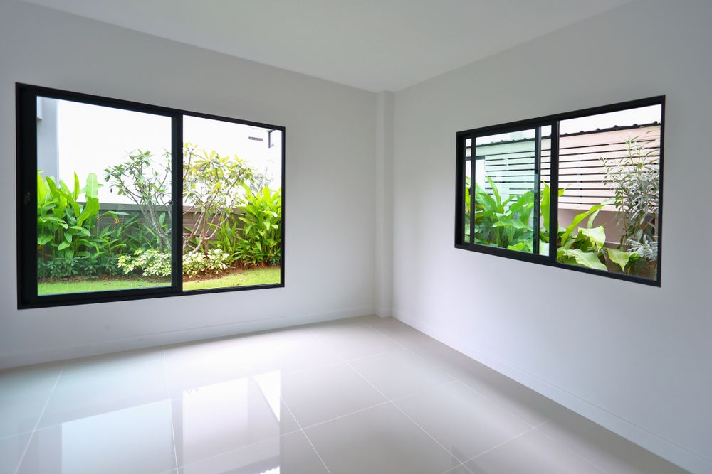 An Empty Room With Two Windows And A Garden In The Background — New England Glass & Aluminium In Moree, NSW