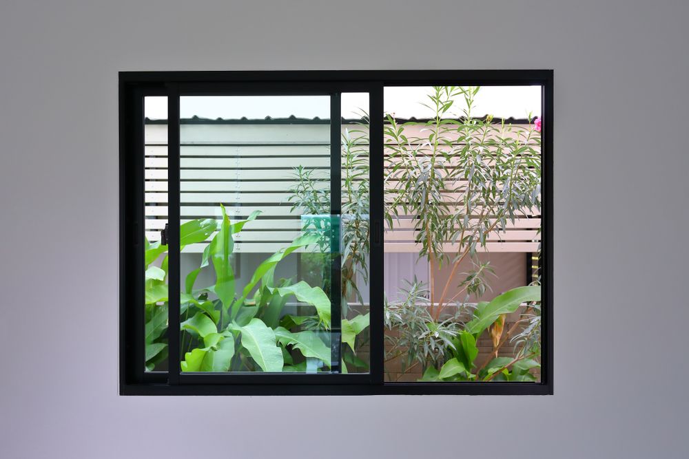A Window With A Sliding Glass Door Looking Out To A Garden — New England Glass & Aluminium In Narrabri, NSW