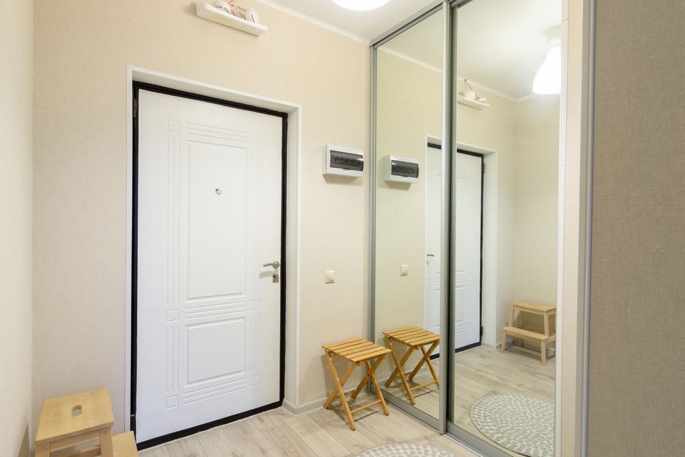 A Hallway With A White Door And A Large Mirror — New England Glass & Aluminium In Armidale, NSW