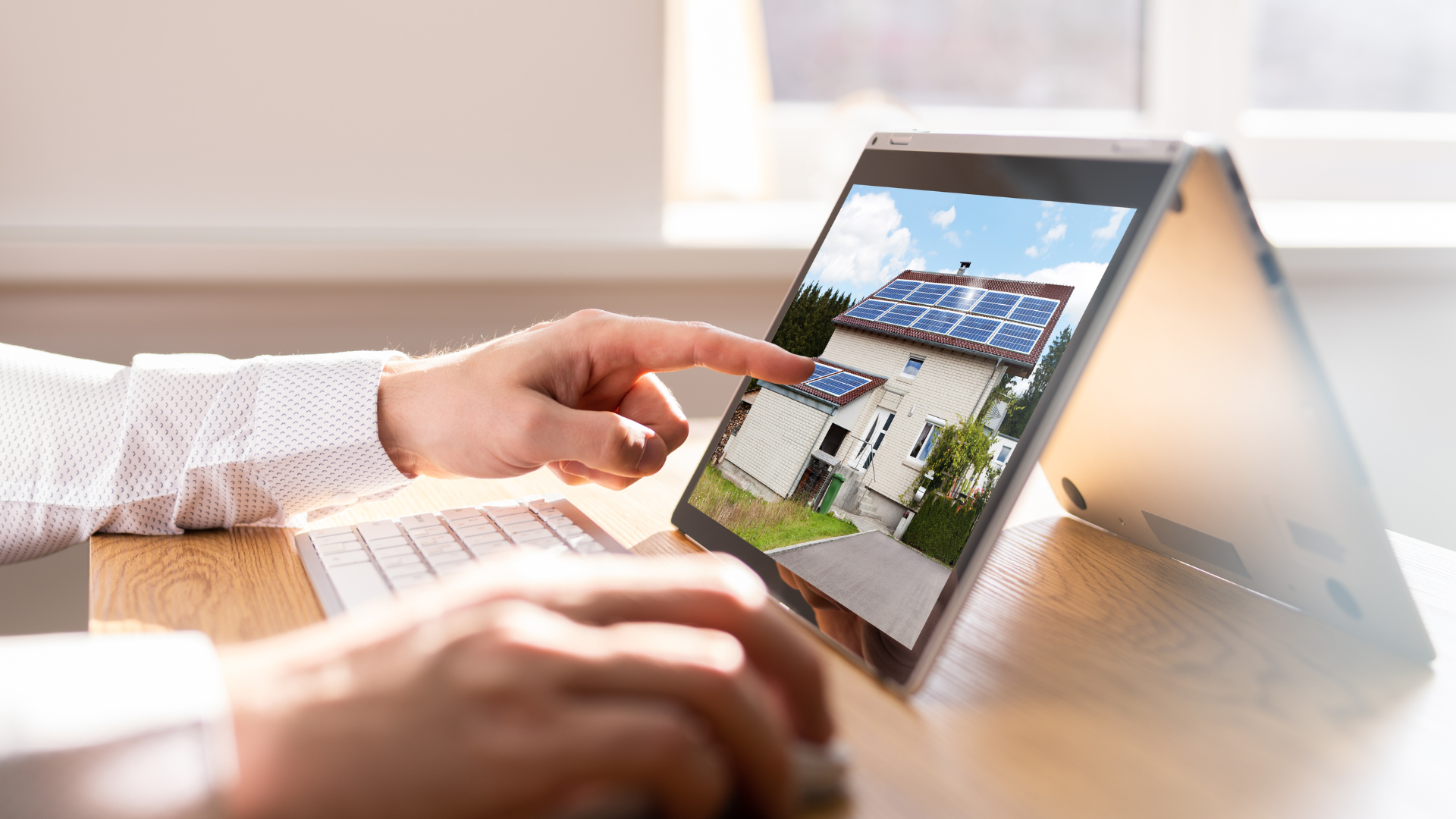 Real estate agent showing paperwork to a couple, signing a contract in a home.