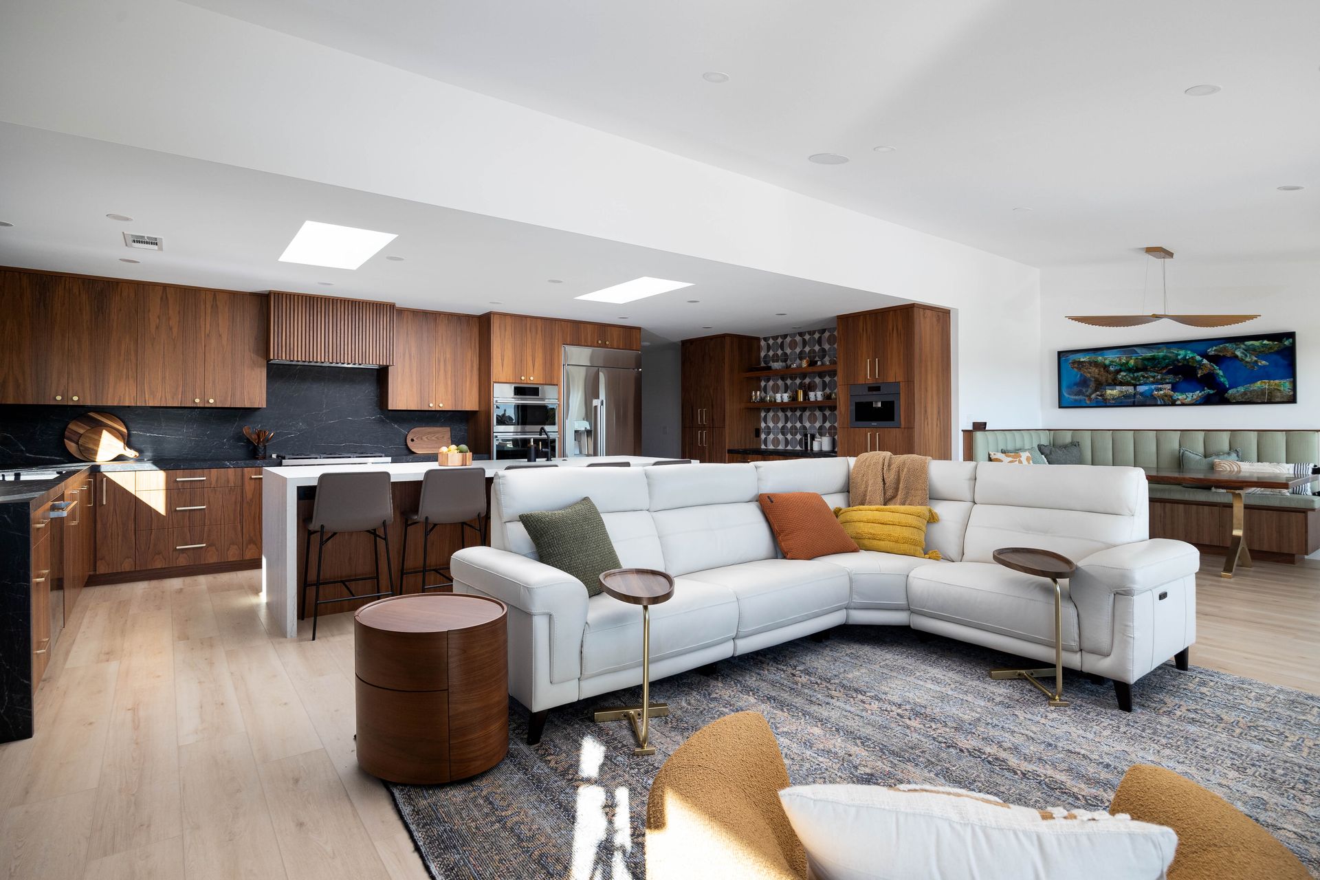 a living room with a white sectional couch and a rug .